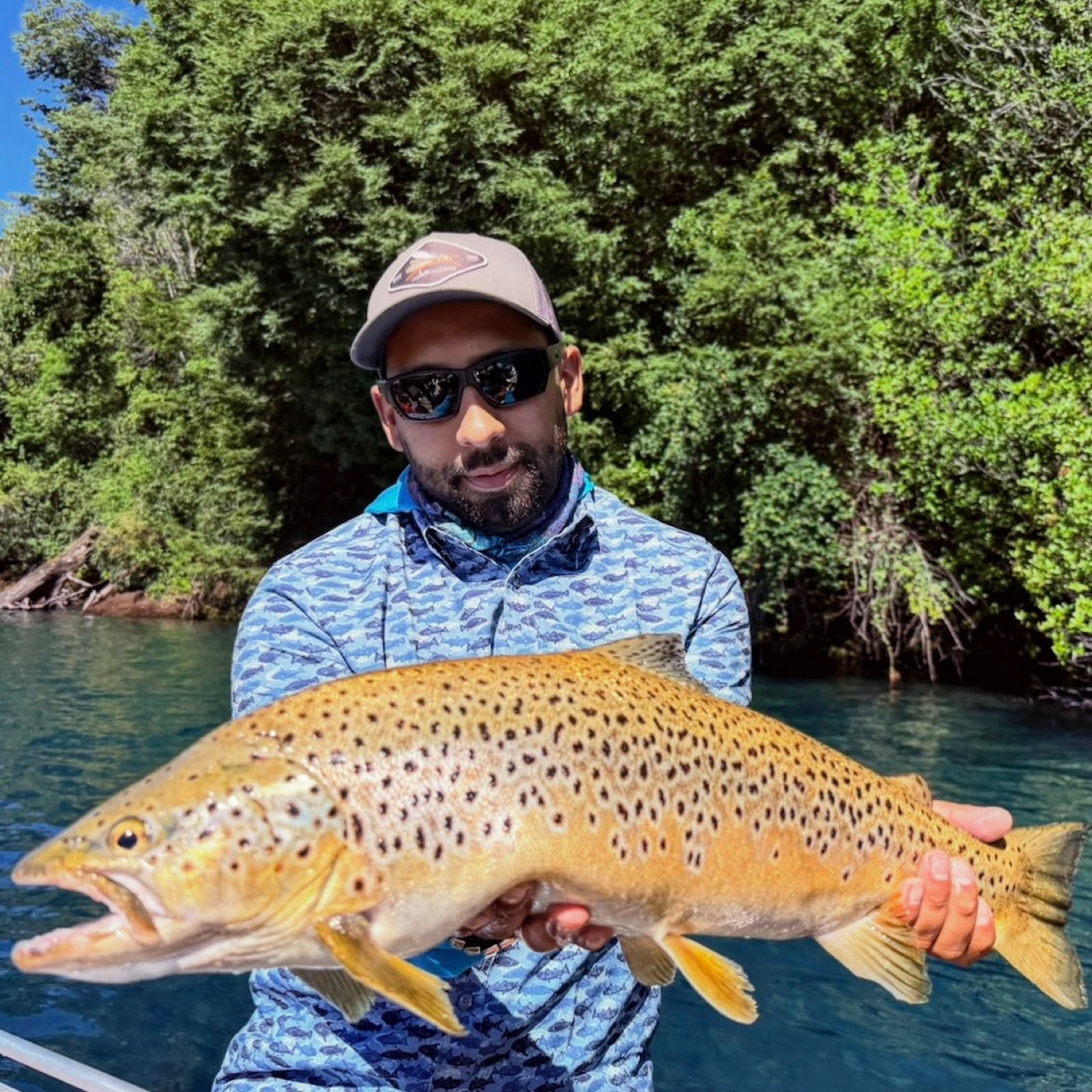 Marcos Quiroz holding a brown trout in Chile's Lake District